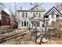 Grey two-story home with manicured lawn and wrought iron fence at 2823 N Lafayette St, Denver, CO 80205