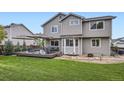 Beautiful backyard featuring a wooden patio set, manicured grass, and outdoor seating at 1641 Cedarwood Dr, Longmont, CO 80504