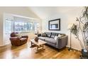 Cozy living room featuring a large window, hardwood floors, and modern decor at 1641 Cedarwood Dr, Longmont, CO 80504
