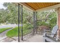 Relaxing front porch with wrought iron columns, offering a peaceful outdoor space with seating at 1635 Winona Ct, Denver, CO 80204