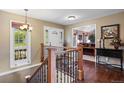 Inviting foyer with hardwood floors, staircase, and front door with decorative glass at 7881 S Ivy Ct, Centennial, CO 80112