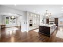 Open-concept kitchen with a center island, custom cabinetry, and high-end stainless steel appliances at 8523 S Flower Ct, Littleton, CO 80128