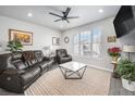 Cozy living room features a brown leather couch, two armchairs, and a coffee table at 9808 Rosalee Peak St, Littleton, CO 80125