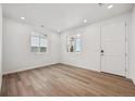 Sunlit living room featuring modern vinyl floors, white walls, and ample natural light at 45934 Gentry Ave, Bennett, CO 80102