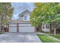 Beautiful two-story house showcasing a three-car garage, well-manicured lawn, and a mature shade tree at 13723 Milwaukee Ct, Thornton, CO 80602