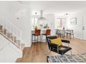 Bright, open-concept living area features wood floors, modern decor, and a staircase to the upper level at 10024 Holland Ct, Broomfield, CO 80021