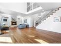 Bright living room with a cozy fireplace, modern sofas, and hardwood floors at 1204 S Balsam Ct, Lakewood, CO 80232