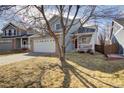 Charming two-story home with a well-manicured front yard and a two-car garage at 1188 Mulberry Ln, Highlands Ranch, CO 80129