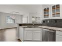 Modern kitchen with granite countertops, stainless steel appliances, and white cabinetry at 200 Whitehaven Cir, Highlands Ranch, CO 80129