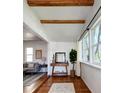 Inviting living room with exposed beams, hardwood floors and natural light at 3469 Benton St, Wheat Ridge, CO 80212