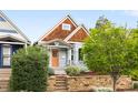 Charming single Gathering home with a quaint front yard featuring a stone retaining wall and unique wood shingle siding at 3425 W 34Th Ave, Denver, CO 80211