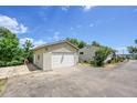 Spacious detached two-car garage with ample parking space and a well-kept exterior and driveway at 3145 S Bryant St, Englewood, CO 80110