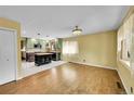 Bright and airy living room with hardwood floors, leading into a kitchen with stylish island at 3145 S Bryant St, Englewood, CO 80110