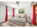Cozy main bedroom featuring neutral decor, a ceiling fan, and stylish curtains framing the window at 857 S Van Gordon Ct # B107, Lakewood, CO 80228