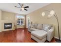 Spacious living room with a fireplace, comfortable seating, and large windows at 17346 Nature Walk Trl # 108, Parker, CO 80134