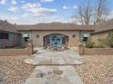 Charming single story home featuring a stone walkway, fountain, and beautifully landscaped front yard at 2653 S Harrington Ln, Lakewood, CO 80227
