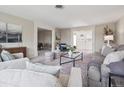 Bright living room with neutral tones, large windows, and elegant decor at 2653 S Harrington Ln, Lakewood, CO 80227