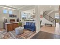 Bright and airy living room featuring modern decor, hardwood floors, and seamless open-concept design at 16002 E 111Th Cir, Commerce City, CO 80022