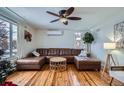 Bright living room showcasing hardwood floors, a comfortable leather sectional, and ample natural light at 3500 W 55Th Ave, Denver, CO 80221