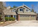 Charming two-story home with a three-car garage, brick accents, and a landscaped front yard with stone path at 10856 Parker Vista Ln, Parker, CO 80138
