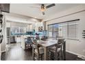 Open-concept kitchen and dining area with modern finishes and lots of natural light at 7998 E Vassar Dr, Denver, CO 80231