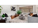 Cozy living room with neutral tones, comfortable seating, and ample natural light at 1454 Jersey St # 104, Denver, CO 80220