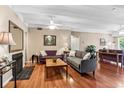Comfortable living room with fireplace, plenty of light, and multiple sofas at 7877 E Mississippi Ave # 208, Denver, CO 80247
