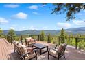 Outdoor deck with ample seating perfect for enjoying stunning mountain views at 187 Marion Dr, Evergreen, CO 80439