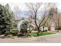 Well-kept home with a manicured lawn, mature trees, and a brick-lined walkway, showcasing its curb appeal at 4530 S Verbena St # 316, Denver, CO 80237