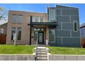 Modern home with a combination of brick and gray siding and well-manicured front lawn at 4351 Yates St, Denver, CO 80212