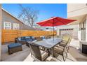 Inviting backyard patio features a large dining table, comfortable seating, and an umbrella for shade at 4351 Yates St, Denver, CO 80212