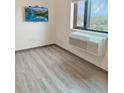 Cozy bedroom with neutral walls, laminate flooring, a mounted TV and a window A/C unit at 603 Inca St # 429, Denver, CO 80204
