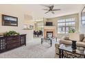 Bright living room with plush carpet, fireplace, and seamless flow to the dining area at 7440 S Blackhawk St # 4-102, Englewood, CO 80112