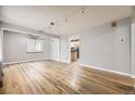 Bright living room with hardwood floors, neutral paint, track lighting and lots of natural light at 1691 Poplar St, Denver, CO 80220