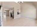Bright living room featuring hardwood floors, neutral walls, with a view into the kitchen and backyard patio at 11542 Community Center Dr # 56, Northglenn, CO 80233