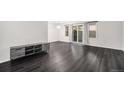 Spacious living room featuring hardwood floors, natural light, and a sliding glass door at 8022 W 78Th Way, Arvada, CO 80005