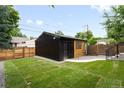 A charming backyard featuring a well-maintained lawn and privacy fence, ideal for enjoying outdoor activities at 4238 Zuni St, Denver, CO 80211