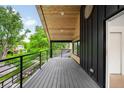 A spacious covered balcony showcases modern railings and wood ceiling at 4238 Zuni St, Denver, CO 80211