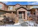 Charming townhome with brick accents and a covered front porch, set in a quiet location at 6480 Silver Mesa Dr # B, Highlands Ranch, CO 80130