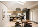 Bright open dining area with modern light fixtures, skylights, and a seamless transition to the kitchen at 11673 W 28Th Ave, Lakewood, CO 80215