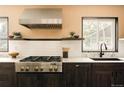 Updated kitchen featuring stainless steel appliances, modern finishes, and a large window for natural light at 11673 W 28Th Ave, Lakewood, CO 80215