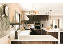 Spacious kitchen with an island, stainless steel appliances, custom cabinetry, and stylish countertops at 11673 W 28Th Ave, Lakewood, CO 80215