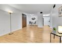 Open-concept living room with wood floors, dining area, and access to the kitchen at 4661 S Decatur St # 109, Englewood, CO 80110