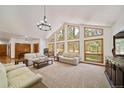 Spacious living room boasts a wall of windows, offering abundant natural light at 5846 S Pike Dr, Larkspur, CO 80118