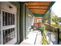 Inviting front porch with metal awning providing shade for a comfortable outdoor space at 3732 N Franklin St, Denver, CO 80205