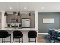 Stylish kitchen with stainless steel appliances, white countertops, and a view into the dining area at 2127 Alcott Way, Broomfield, CO 80023