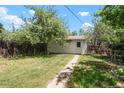 The backyard features a shed, lawn, garden beds, and a walking path at 1160 S Steele St, Denver, CO 80210