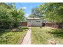 Backyard featuring a lawn, a shed and garden beds at 1160 S Steele St, Denver, CO 80210