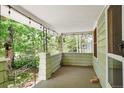Covered porch with hanging lights, wood flooring and railing at 1160 S Steele St, Denver, CO 80210