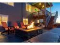 Inviting backyard fire pit with Adirondack chairs, perfect for outdoor entertaining and relaxation at 17851 Herrera Dr, Parker, CO 80134